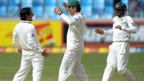 Pakistan's Saeed Ajmal, captain Misbah-ul-Haq and Azhar Ali celebrate a wicket