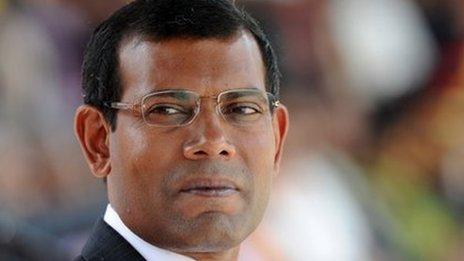 In this photograph taken on December 27, 2011, Maldivian President Mohamed Nasheed looks on while attending a military parade in the central Sri Lankan town of Diyatalawa