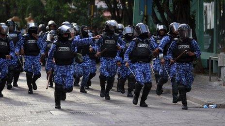 Maldivian riot police chase away the supporters of the ousted Maldivian president Mohamed Nasheed during a clash in Male February 8, 2012