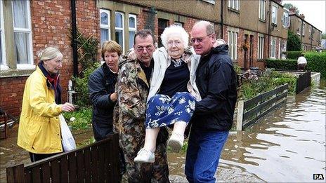 Residents of Morpeth, Northumberland leave their flooded homes following a night of rising floodwaters in the town. September 2008.