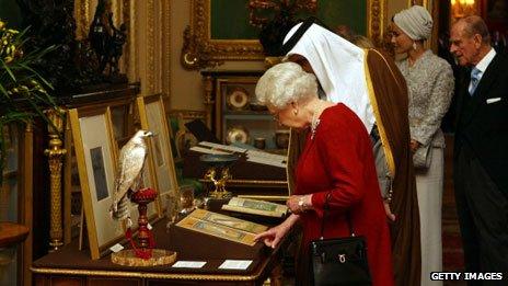 Queen Elizabeth II shows the Emir of Qatar, Sheikh Hamad bin Khalifa al-Thani, around exhibits from the Royal Collection