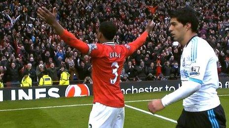 Patrice Evra celebrates in front of the Stretford End