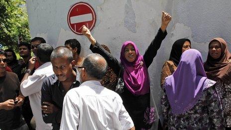 Supporters of former president outside hotel where he held talks with US diplomat Robert Blake - 11 February