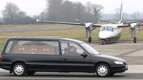 Bob Jones's coffin is driven past a plane