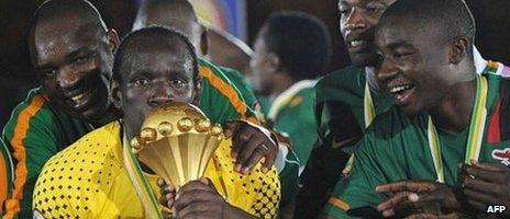 Zambia's goalkeeper Kennedy Mweene (L) kisses the trophy during the award ceremony following their African Cup of Nations (CAN 2012) match against Ivory Coast on 11 February 2012 at the stade de 'Amitie in Libreville. Zambia conjured up a shock when they toppled star-studded Ivory Coast 8-7 in a penalty shoot-out to claim their first ever Africa Cup of Nations title. AFP PHOTO / FRANCK FIFE (Photo credit should read FRANCK FIFE/AFP/Getty Images)