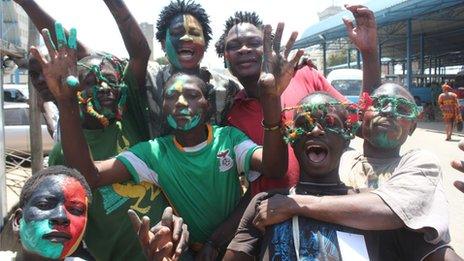 Zambian fans with painted faces celebrate their victory over Ivory Coast