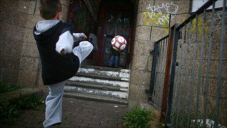 Child kicking football