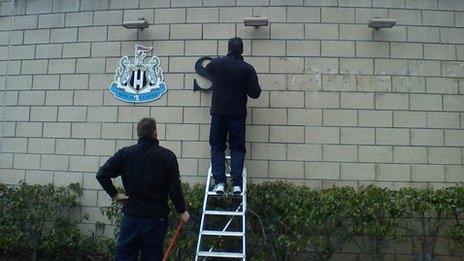 The St James' Park sign being removed