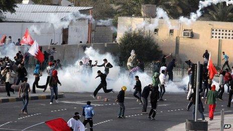 Riot police fire tear gas to disperse anti-government protesters on a road near Manama (13 February 2012)