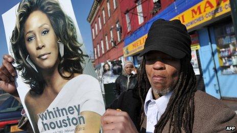 Fan holds picture of Whitney Houston