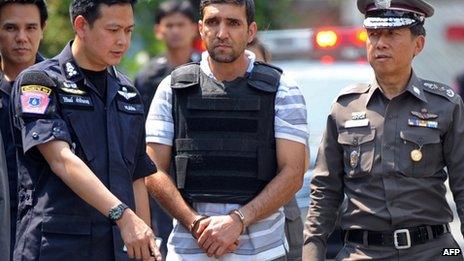 Thai police escort suspect Mohamad Khazaei to the scene of the first blast in Bangkok, 20 February