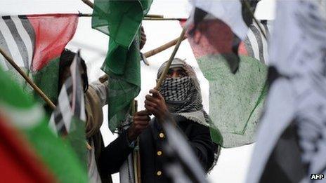 Activists of Pakistani Islamist groups and political parties hold their party flags during an anti-US protest rally in Islamabad on February 20, 2012