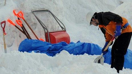 Man digging in snow in Japan