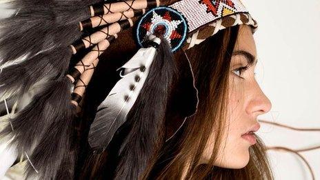 Model wears a head dress