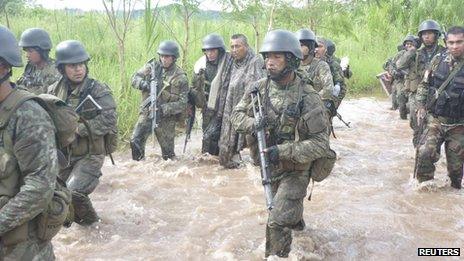 Shining Path leader Comrade Artemio (centre without helmet) is escorted by soldiers after his capture - photo taken 12 February 2012