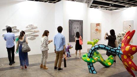 Visitors at ART HK look at an exhibit in May last year