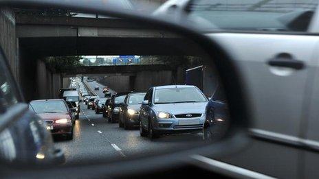 Reflection of traffic in a car wing-mirror