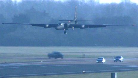 The U-2 coming into land with the chase cars following it along the runway