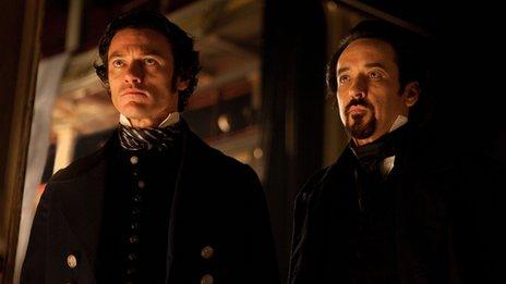 Luke Evans and John Cusack in the Raven