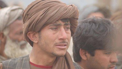 A distraught man near the scene of the killings in Kandahar, 11 March