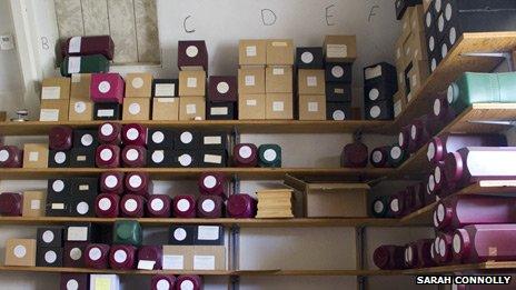 Labelled boxes of uncollected ashes at a Bristol funeral director's premises