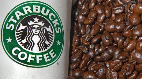 Starbucks cup and coffee beans