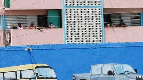 Residents of the Tivoli Gardens district of Kingston, Jamaica, watch as a press tour passes in May 2010, soon after troops entered the area to fight drug gangs.