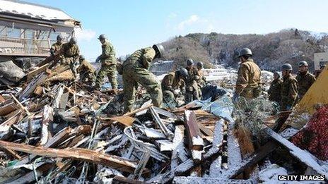 Japanese military personnel searching for survivors