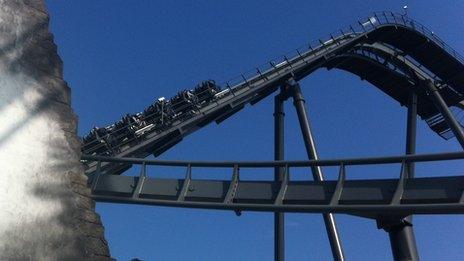 Passengers on shut-down roller coaster