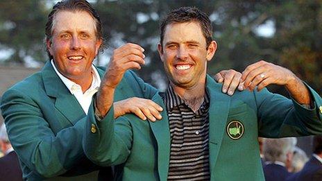 Charl Schwartzel receives his Green Jacket from 2010 champion Phil Mickelson