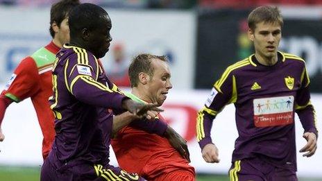 Purple-clad Chris Samba (left) in action against Lokomotiv Moscow