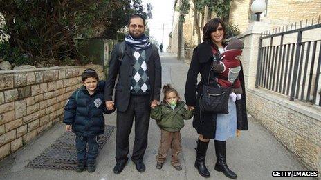 Jonathan Sandler with his sons Arieh (left) and Gabriel (right), and his wife Eva and baby daughter, in an undated image