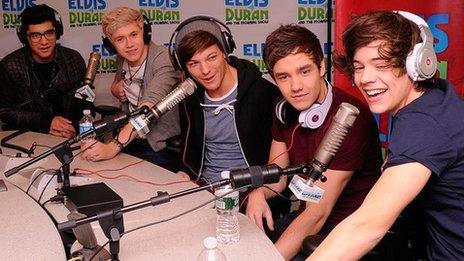 One Direction sitting in a radio studio