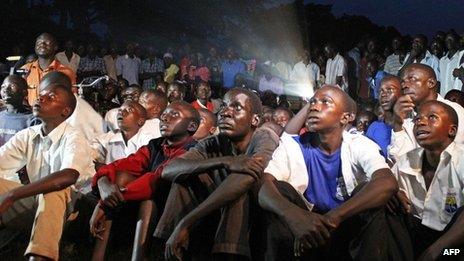 Ugandans watch the screening of Kony 2012, a 30-minute YouTube film uploaded by US campaign group Invisible Children, in Lira district, on 13 March 2012