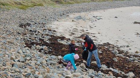 Volunteers collecting and recording litter on a Guernsey beach