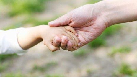 Child holding an adult's hand