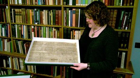 Archivist Ellie Jones with Edward the Confessor's Charter