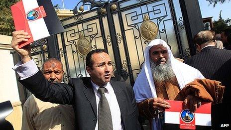 Presidential candidate hopefuls Alhusseiny Amer (left) and Abdulbaset Suleiman (right) hold folders after registering their names for the election in Cairo