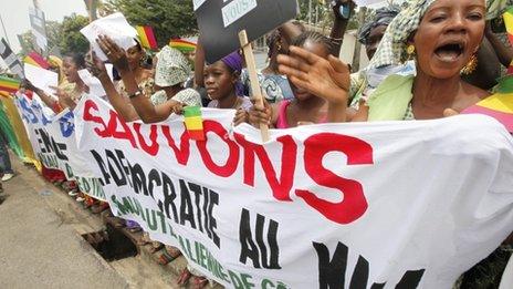 Malians living in Ivory Coast protest against a coup in their country during the Extraordinary Meeting of ECOWAS in Abidjan