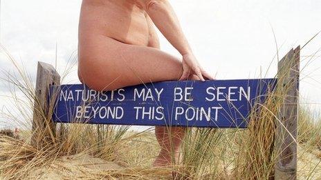 A sign at a nudist beach