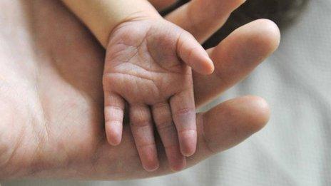 Hands of mother and baby