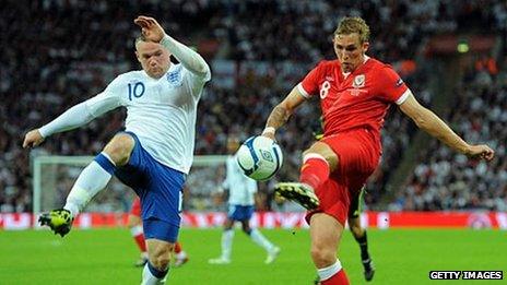 England's Wayne Rooney and Wales's Craig Bellamy in Euro 2012 qualification action