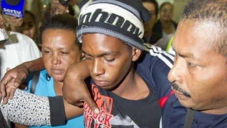 Rescued castaway Adrian Vasquez, second from right, surrounded by family members