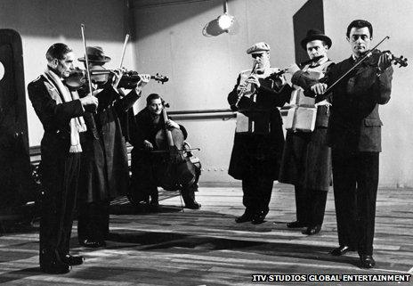 Musicians on the deck of the Titanic in the film A Night To Remember (1958)