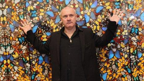 Damien Hirst in front of his Doorways to the Kingdom of Heaven artwork