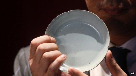 Sotheby’s Asia Deputy Chairman Nicolas Chow holds the Ruyao washer