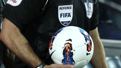 Referee holding a ball