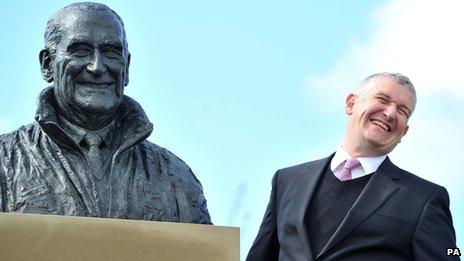 Donald McCain with a bust of his father, Ginger