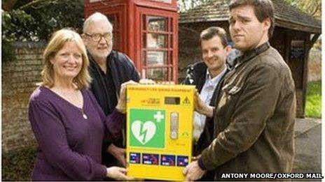 Beth Chesney-Evans pictured with the phone box and, pictured left to right, Crispin Evans, Tom Bowtell, chairman of Long Wittenham Parish Council, and Charles Evans.