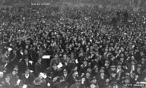 Protesters giving clenched fist salute at a No To Hitler rally in Saarland, Germany, 1935